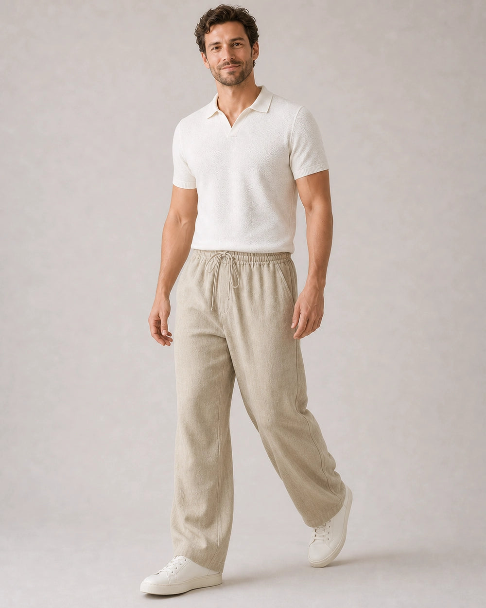 Man walking in beige linen wide-leg pants, showing movement and drape.