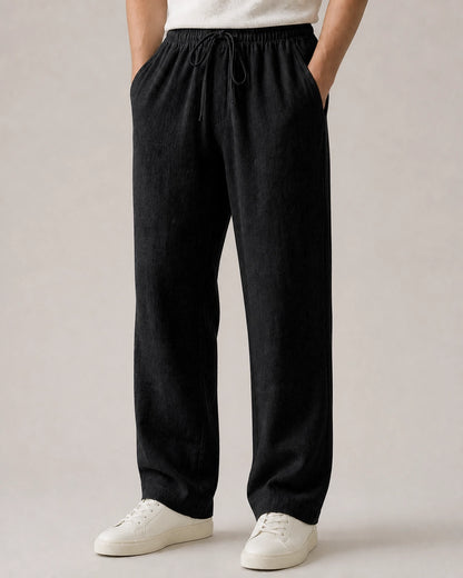 Men’s black linen wide-leg pants with elastic drawstring waist.