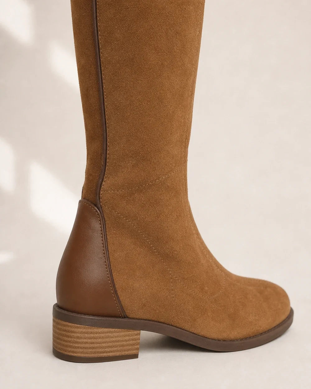 Women's camel suede-effect knee-high boot, heel counter and seam detail.