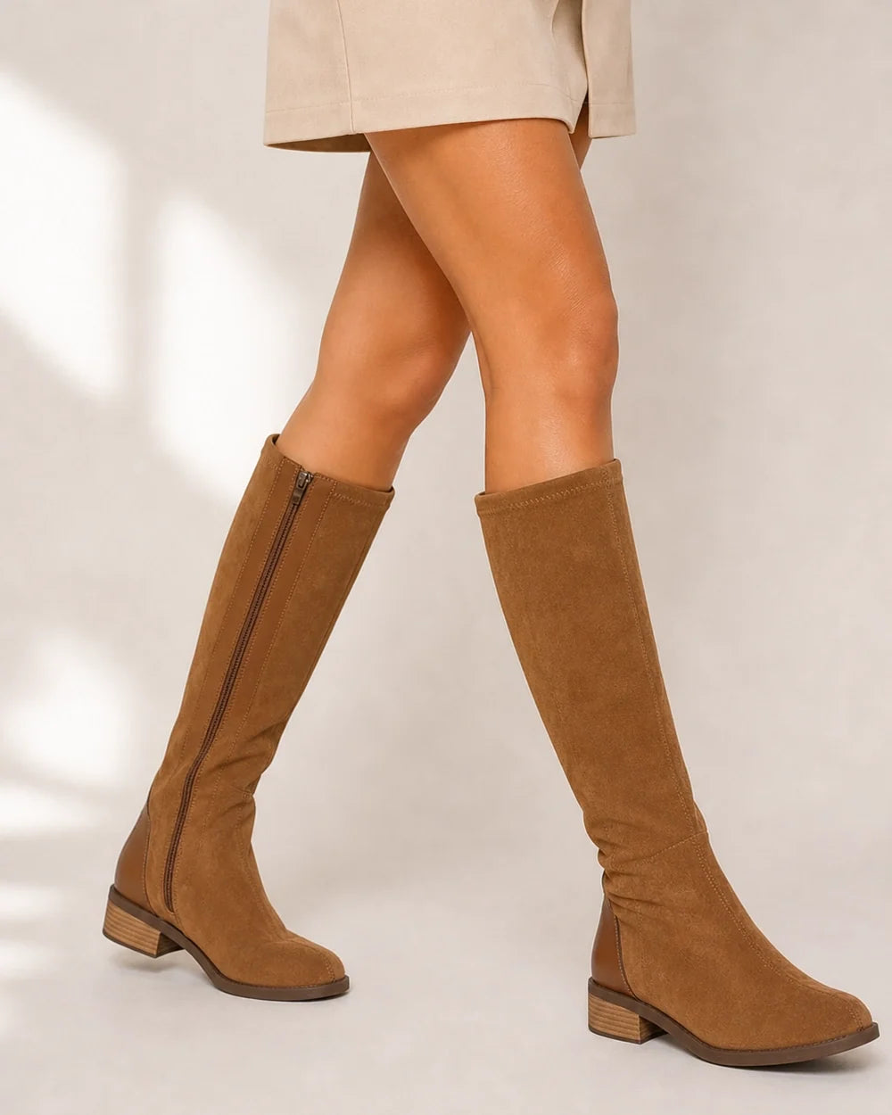 Women's camel suede-effect knee-high boots, natural walking view.