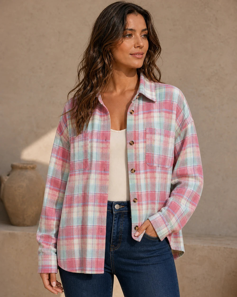 Women's pink pastel oversized plaid shirt, front three-quarter worn view. — momount-womens-oversized-plaid-shirt-pink-09-hero.webp