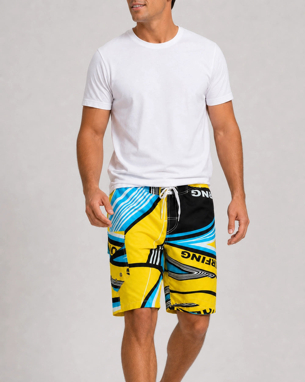 Man walking in blue and yellow geometric knee-length swim shorts.