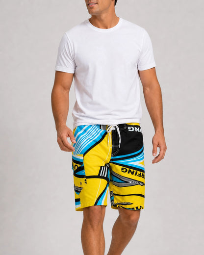 Man walking in blue and yellow geometric knee-length swim shorts.