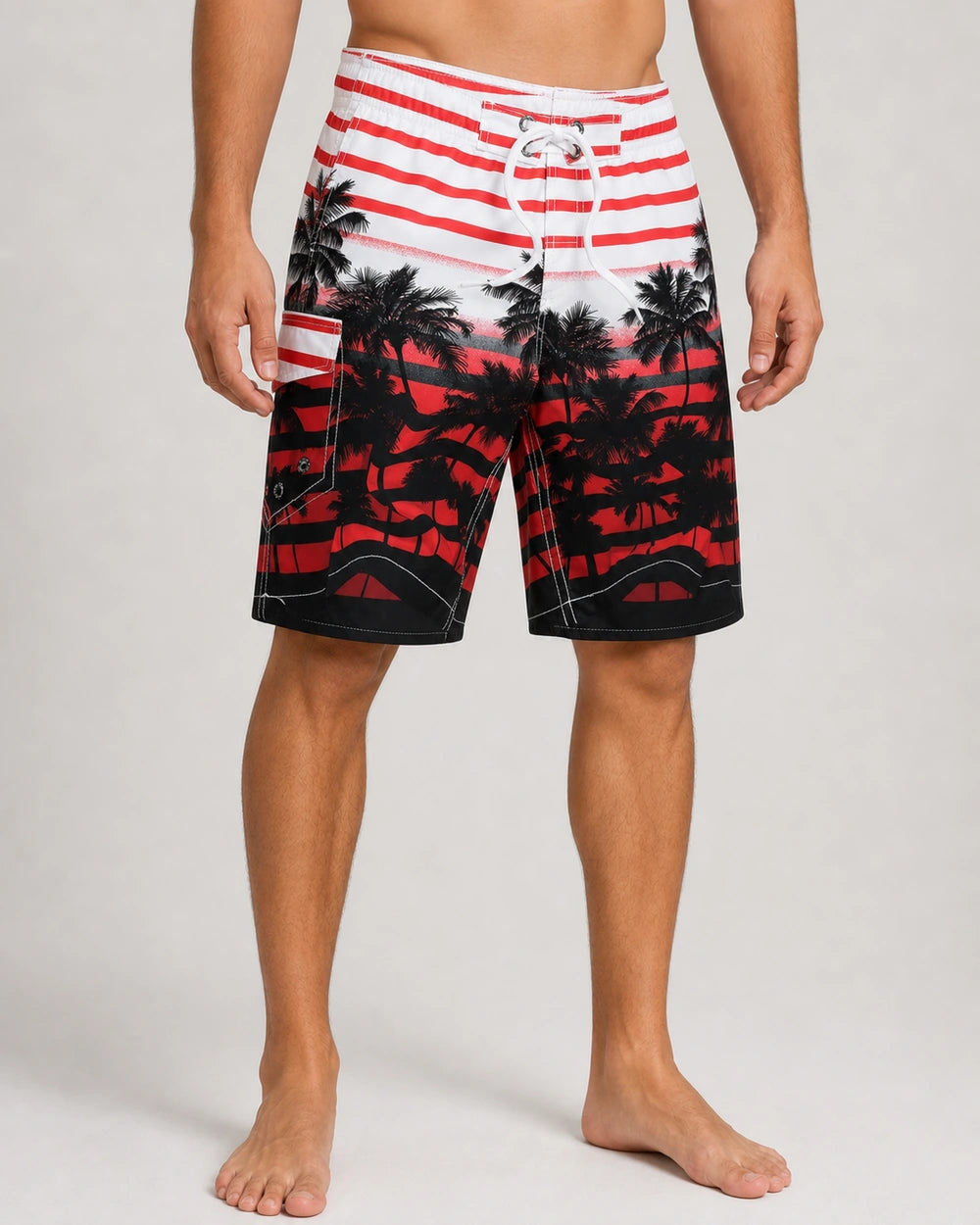 Red and black palm-print knee-length swim shorts, front view.