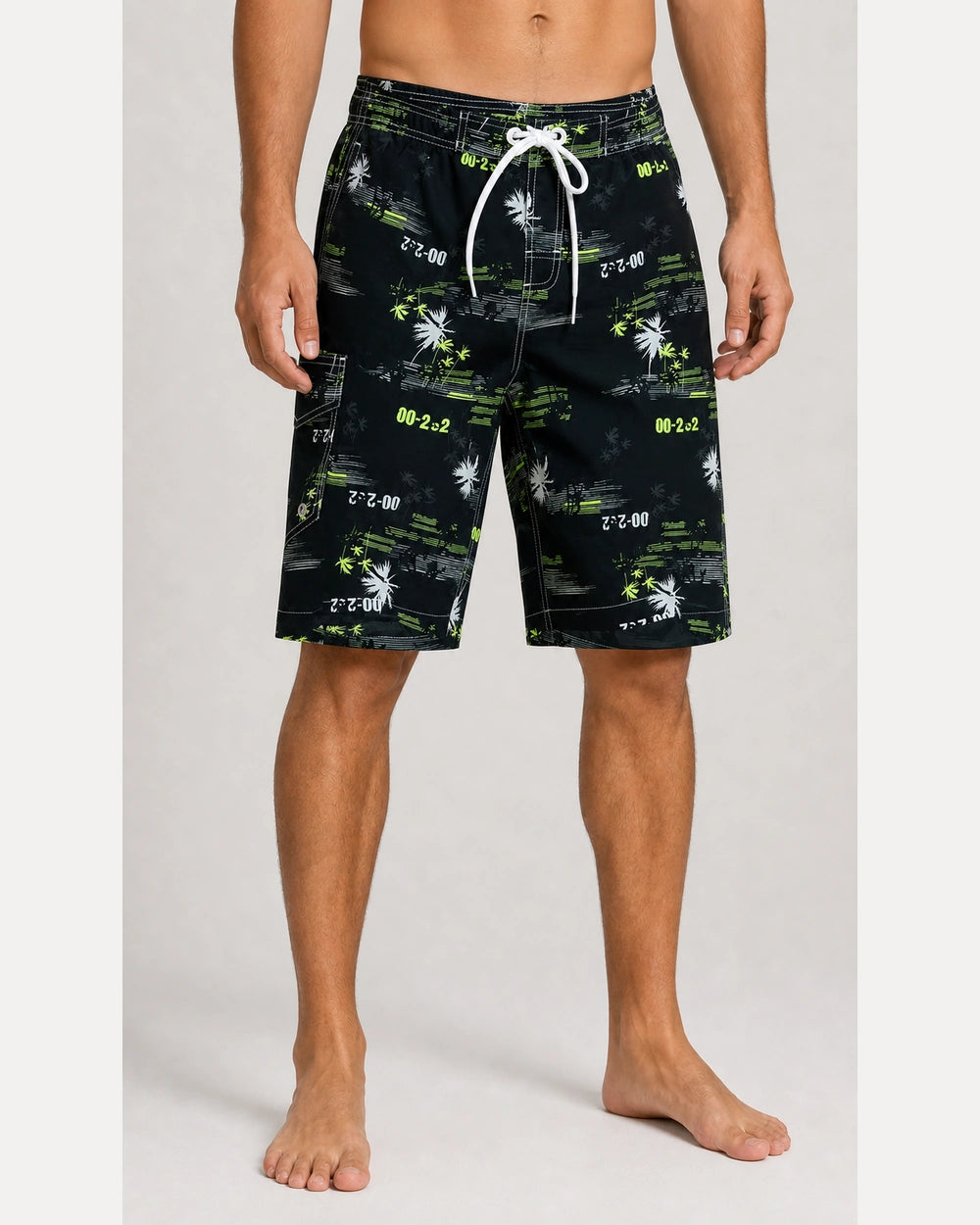 Black and lime graphic knee-length swim shorts, front view.